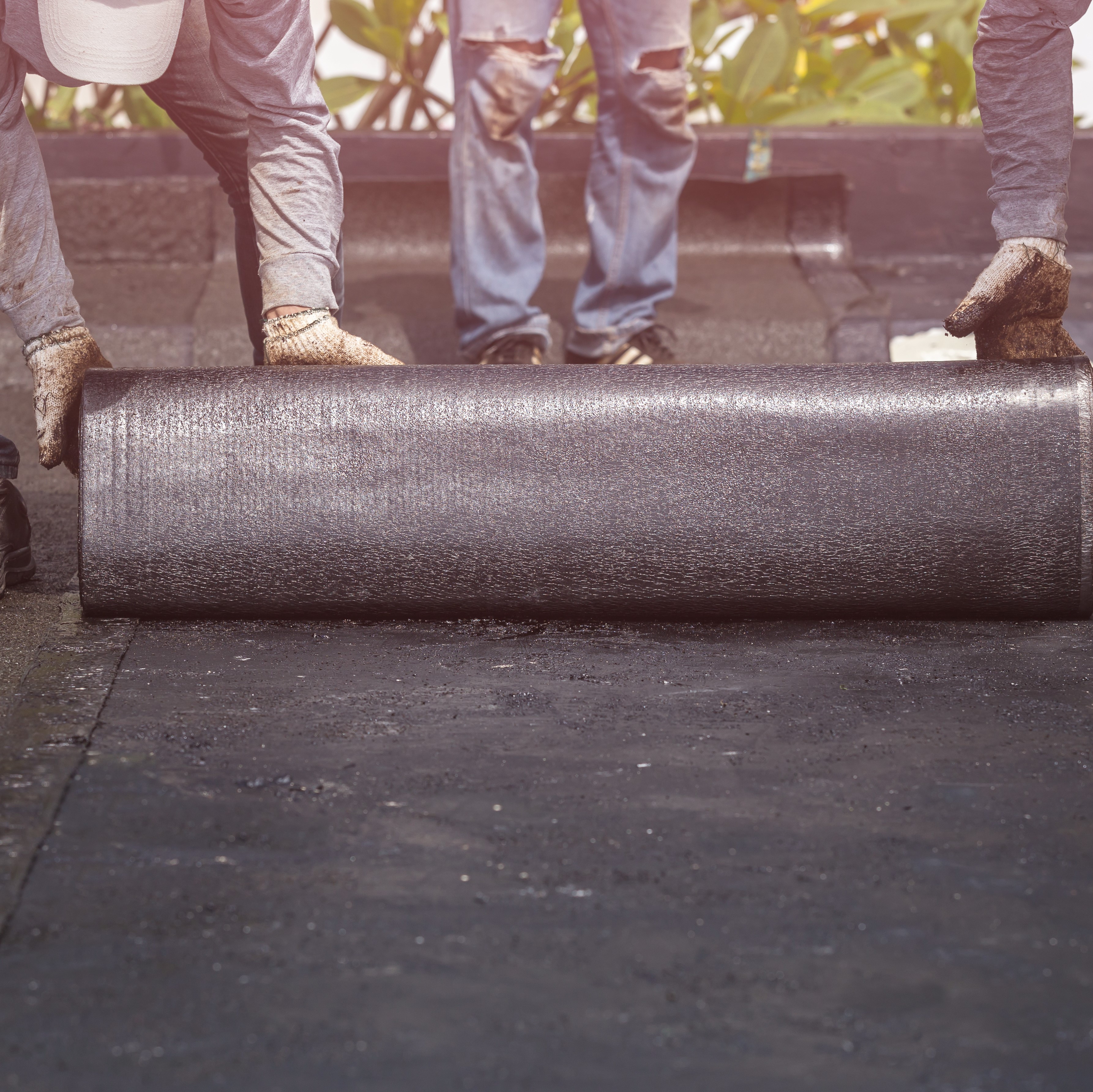 Roofers Applying Single-ply Roofing.