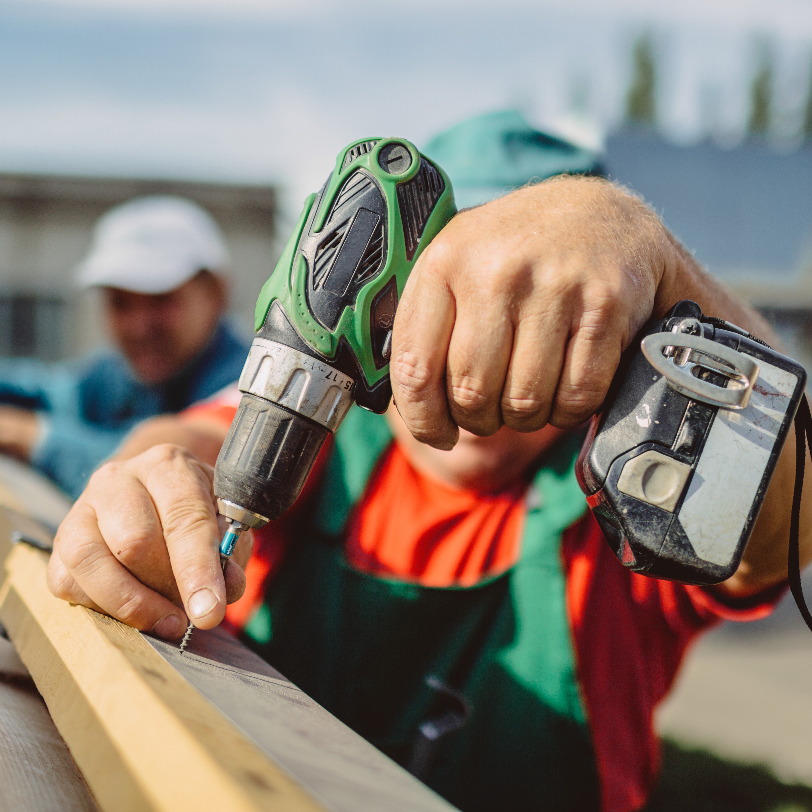 A Roofing Contractor Works on a Roof.